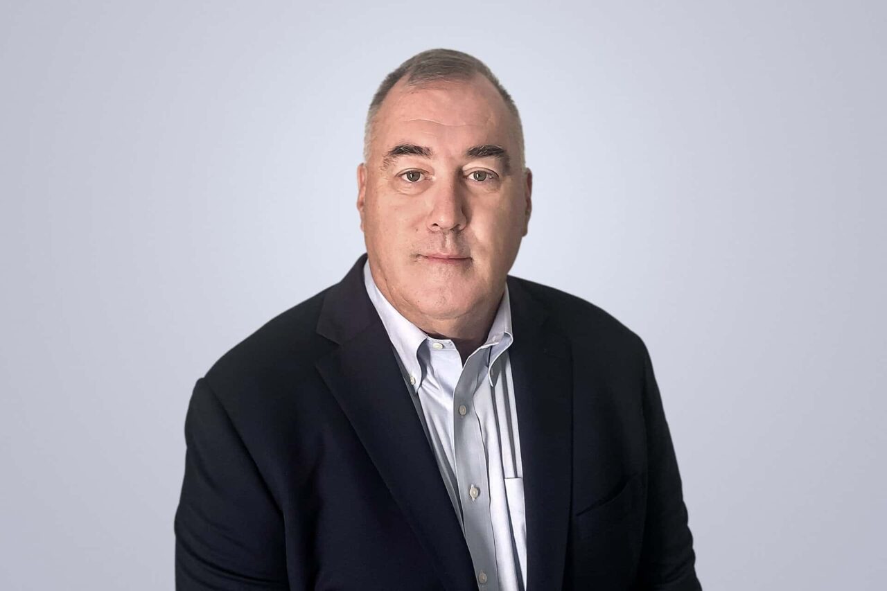 Business professional in a suit, aiding manufacturers, distributors, and end users grow with the right connections.