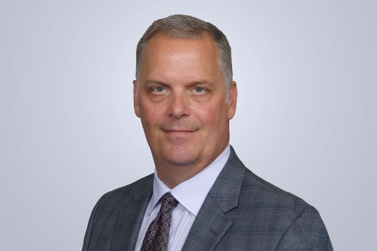 Business professional in a suit, representing helping manufacturers and distributors make the right connections.