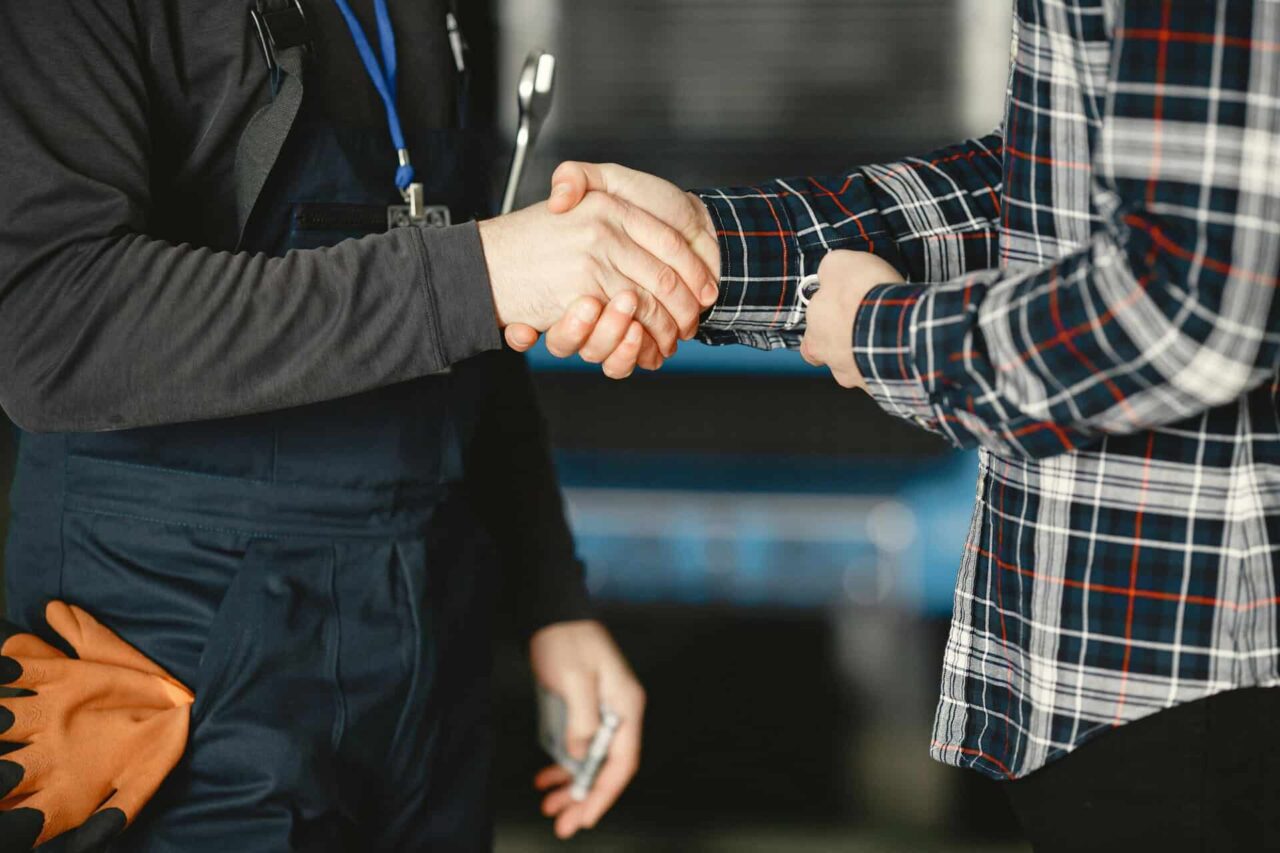 Handshake symbolizing helping manufacturers, distributors, and end users grow through right connections.