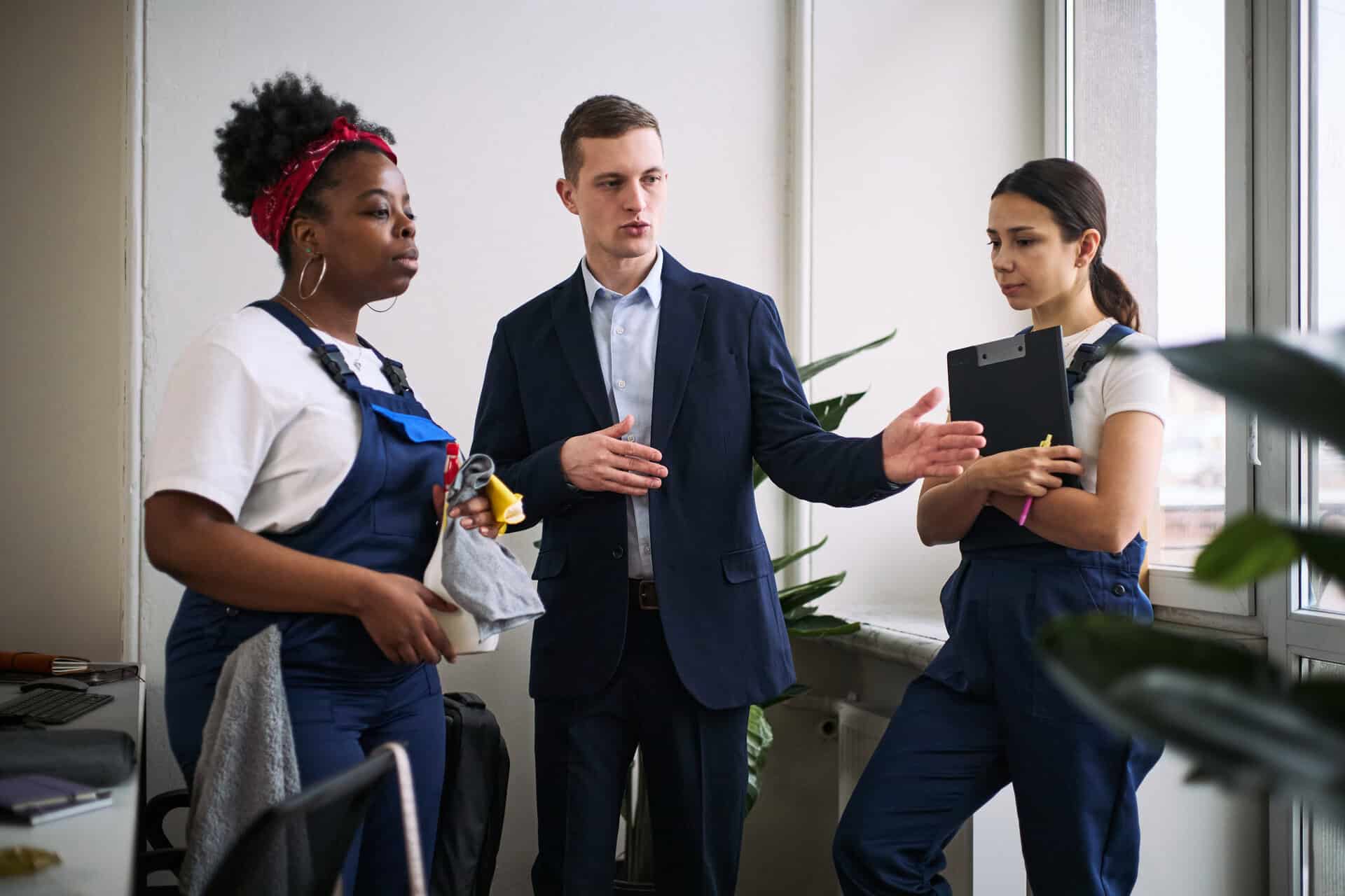 Team discussion among diverse professionals in a modern office, highlighting nationwide manufacturers representative services.