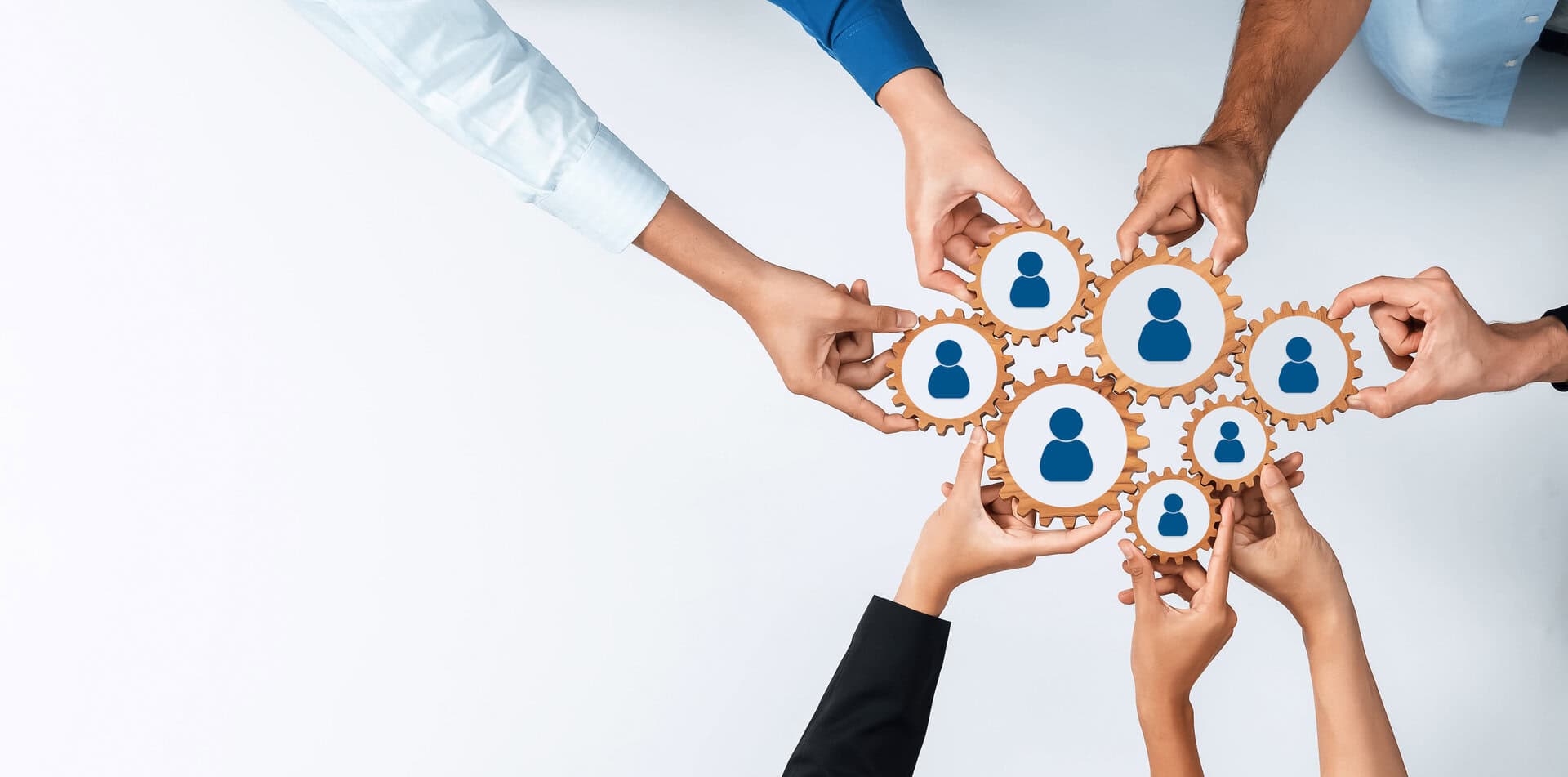 Hands connecting interlocking gears with human icons, symbolizing a nationwide manufacturers representative agency.