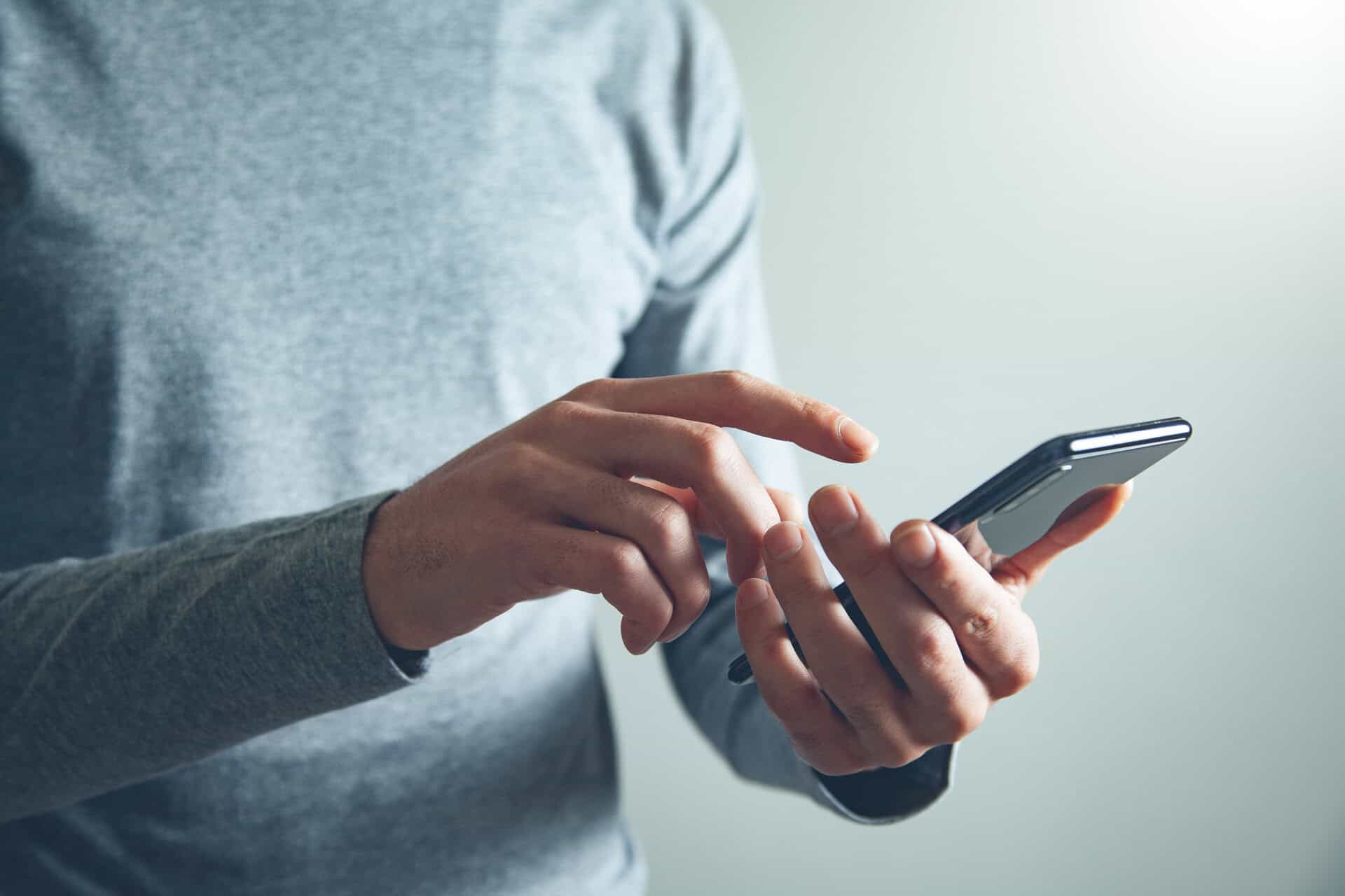Person using a smartphone to connect with trusted food service manufacturers' representative experts.
