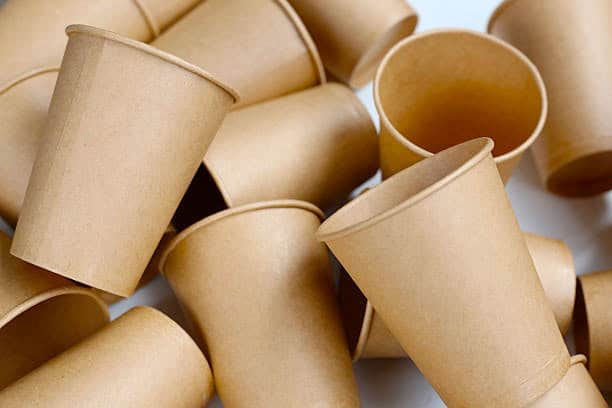 Brown paper cups stacked together, representing food service packaging solutions for manufacturers.