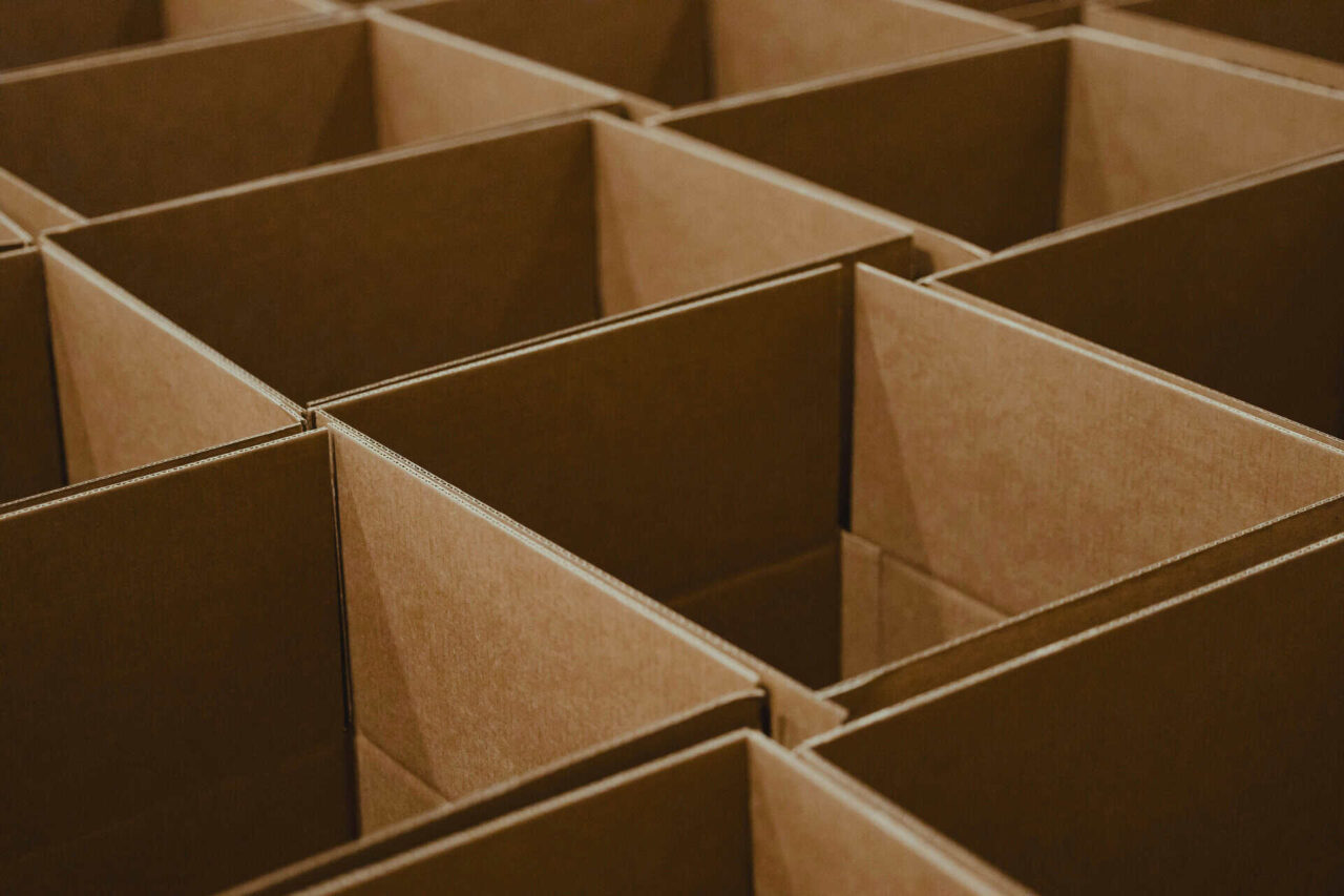 Empty cardboard boxes arranged in rows, symbolizing distribution readiness and efficient product expertise for distributors.