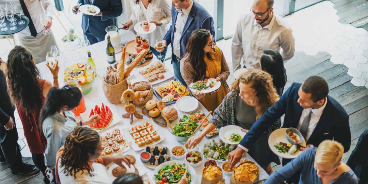 Buffet gathering with diverse end users accessing trusted disposable packaging, showcasing food service supplies through our network.