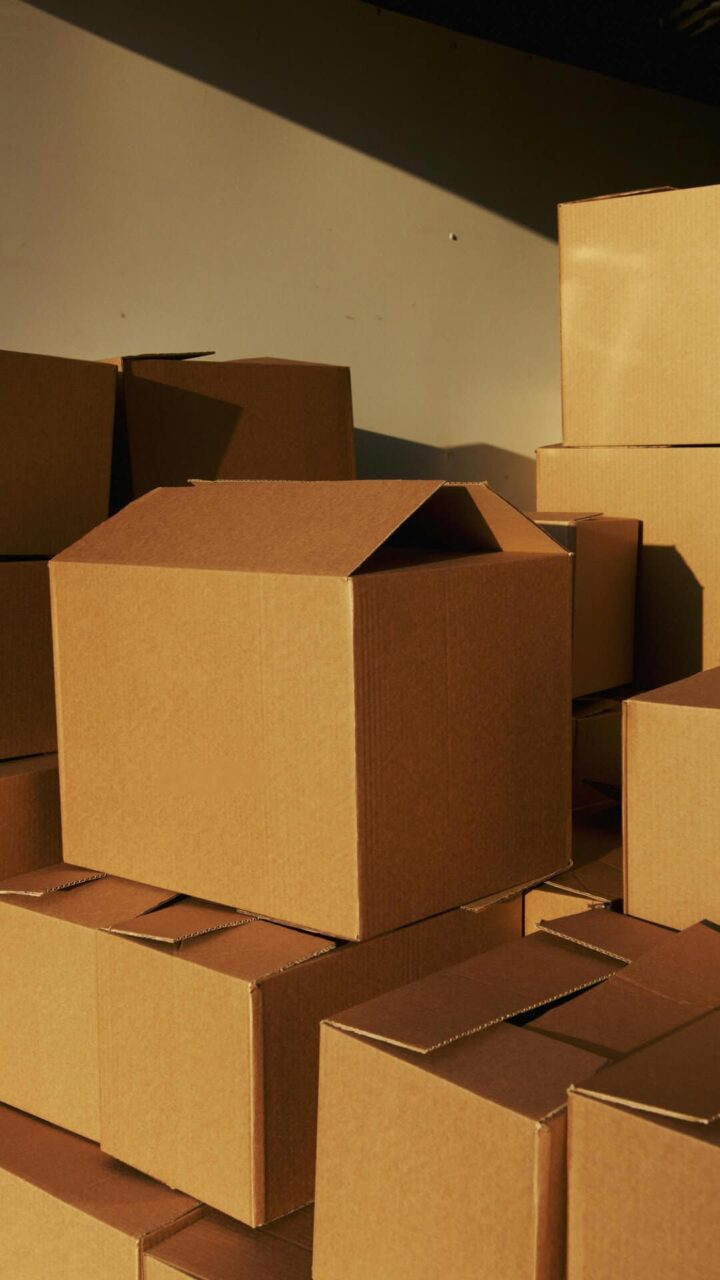 Stacked cardboard boxes ready for distribution by trusted janitorial manufacturers' representative experts.